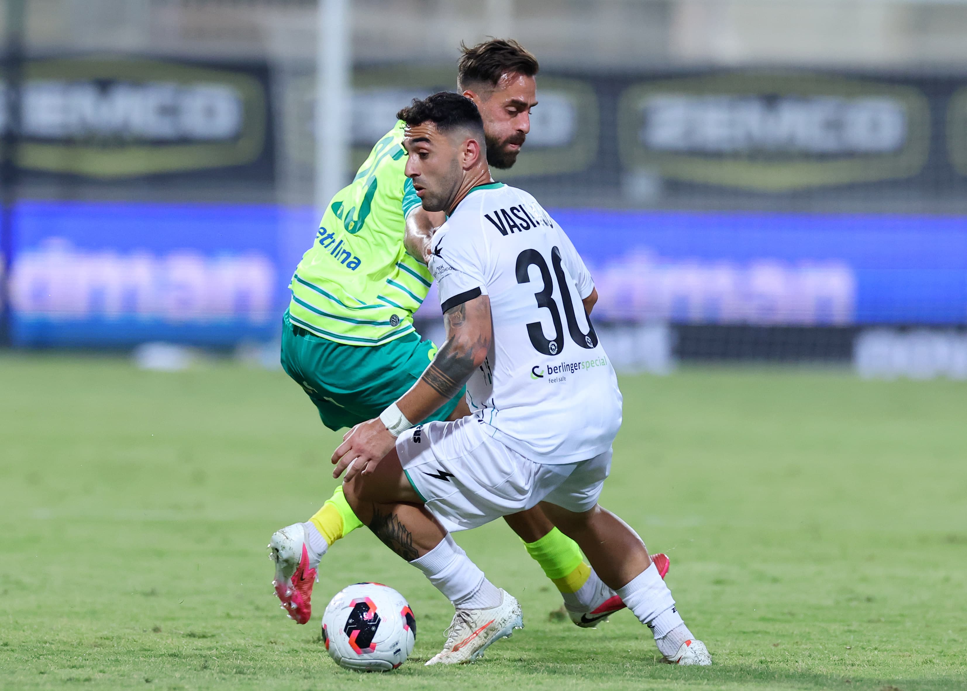 Akritas and AEK Larnaca players contest possession during their Coca-Cola Cup match