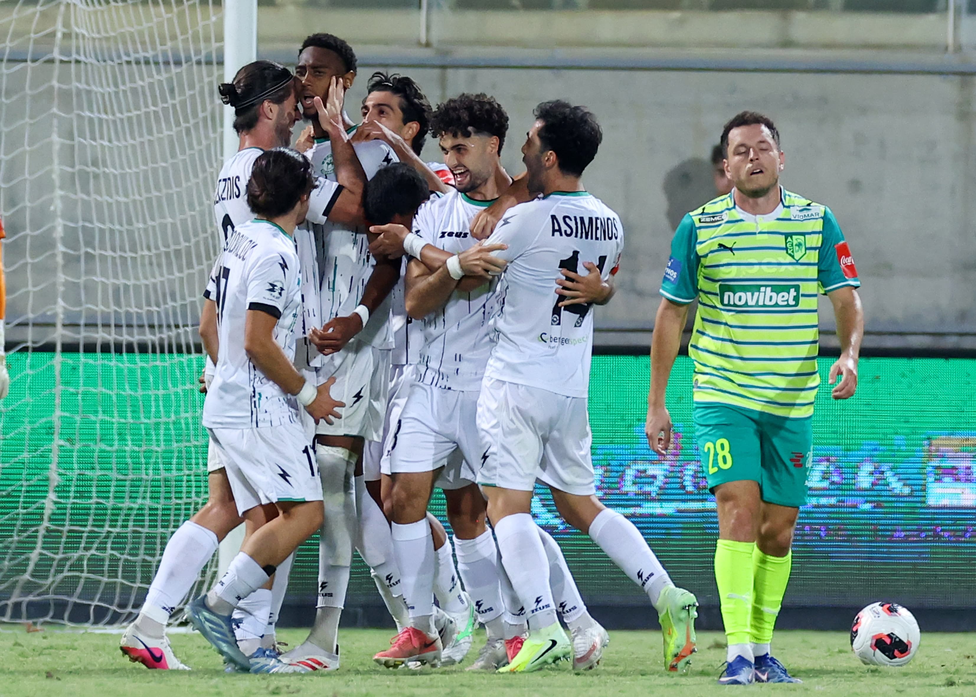 Akritas players celebrate together after scoring against AEK Larnaca