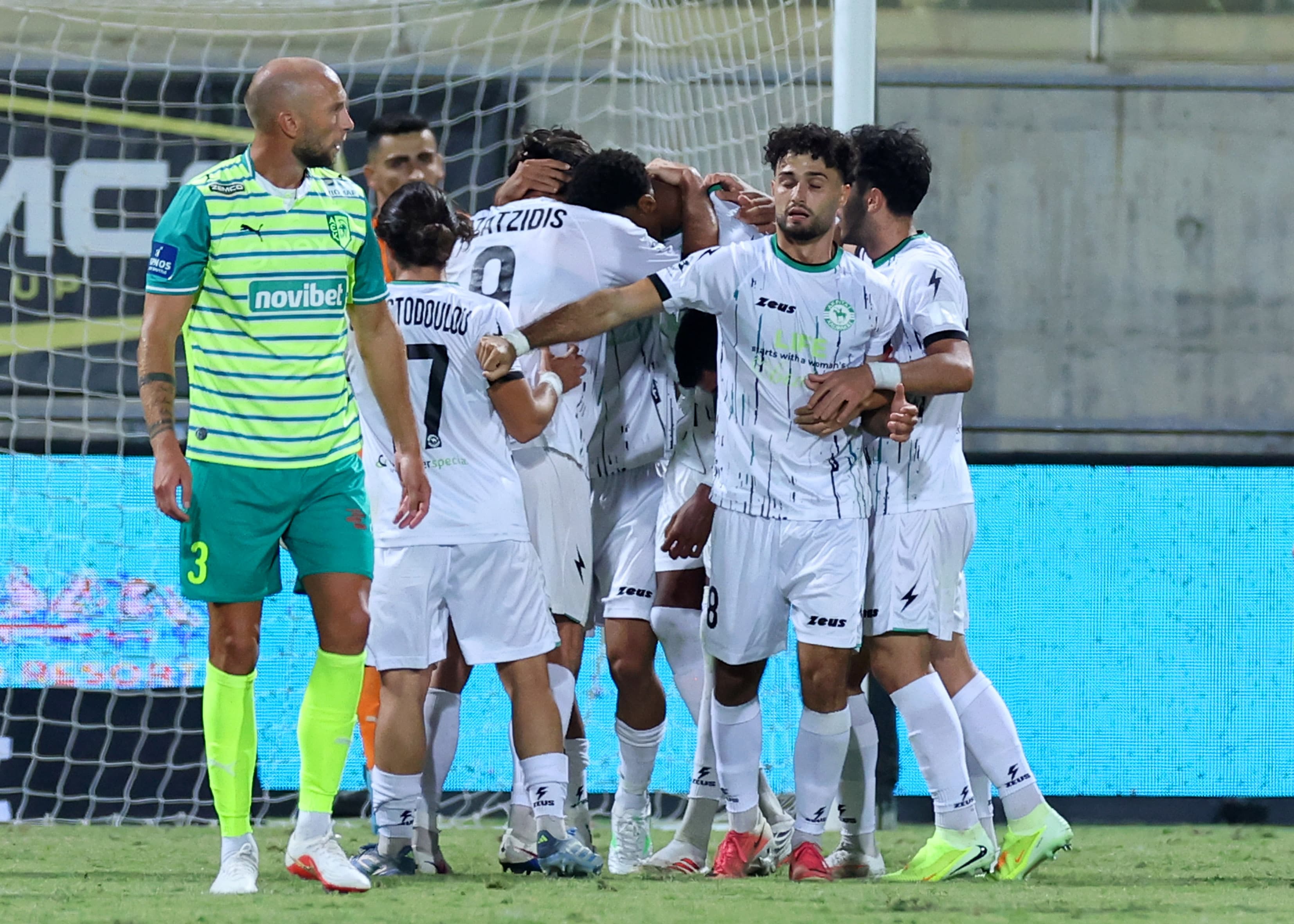 Akritas players huddle together during the match in Larnaca